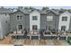 Modern townhouse exterior featuring private balconies over individual garages and backyard access, enhancing curb appeal at 3458 W 63Rd Ave, Denver, CO 80221