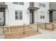 Inviting townhome with wood fence, manicured front yard, and covered entryway, showcasing modern curb appeal at 3458 W 63Rd Ave, Denver, CO 80221
