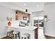 Modern kitchen with stainless steel appliances, wood cabinets, pendant lighting, and a view to an outdoor patio at 3458 W 63Rd Ave, Denver, CO 80221