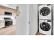 Convenient laundry area with modern stacked washer and dryer, located near the kitchen and other living spaces at 3458 W 63Rd Ave, Denver, CO 80221