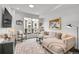 Bright and airy living room with a comfortable sofa, large windows, and stylish decor at 3458 W 63Rd Ave, Denver, CO 80221