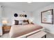 Bright and airy main bedroom with a comfortable bed, stylish decor, and ample natural light at 3458 W 63Rd Ave, Denver, CO 80221