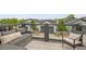 Cozy outdoor patio with comfortable seating, string lights, and a view of the well-manicured lawns in the community at 3458 W 63Rd Ave, Denver, CO 80221