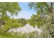 Scenic pond framed by lush trees and greenery, creating a serene and peaceful natural setting at 3458 W 63Rd Ave, Denver, CO 80221