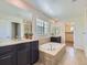 Luxurious bathroom boasts a soaking tub, dual vanities, and designer finishes at 10045 Copenhagen St, Parker, CO 80134