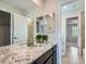 Bathroom featuring double sinks, granite countertop and a modern mirror at 10045 Copenhagen St, Parker, CO 80134