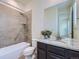 Bright bathroom features a shower over tub, modern vanity, and granite countertop at 10045 Copenhagen St, Parker, CO 80134