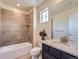 Elegant bathroom featuring a tiled shower, granite countertop and a modern sink at 10045 Copenhagen St, Parker, CO 80134