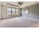 Spacious bedroom with neutral carpet, ceiling fan, and an abundance of natural light at 10045 Copenhagen St, Parker, CO 80134