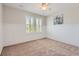 Charming bedroom with white wainscoting, carpet flooring, and large shuttered windows at 10045 Copenhagen St, Parker, CO 80134