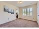 Bright bedroom featuring neutral walls, carpet flooring, and large shuttered windows at 10045 Copenhagen St, Parker, CO 80134
