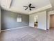 Expansive bedroom with neutral carpet and tray ceiling leading to an en-suite bathroom at 10045 Copenhagen St, Parker, CO 80134