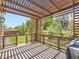 Outdoor deck with a pergola and railing overlooking a grassy yard at 10045 Copenhagen St, Parker, CO 80134