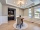 Elegant dining room featuring a modern chandelier, built-in cabinets, and wainscoting at 10045 Copenhagen St, Parker, CO 80134