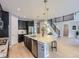 Modern kitchen featuring a large island and open floor plan with hardwood floors and stairs at 10045 Copenhagen St, Parker, CO 80134