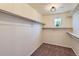 Large walk-in closet provides ample storage with custom shelving and a window at 10045 Copenhagen St, Parker, CO 80134