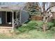 Backyard with wooden deck, green grass and a wooden fence at 19025 E Bethany Pl, Aurora, CO 80013