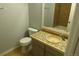 Bathroom with tiled countertop and backsplash, stylish sink, and a toilet at 19025 E Bethany Pl, Aurora, CO 80013