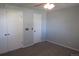 Bedroom with plush carpet, ceiling fan, and dual closets for ample storage at 19025 E Bethany Pl, Aurora, CO 80013