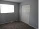 Bedroom with neutral walls, closet with bi-fold doors, and a window for natural light at 19025 E Bethany Pl, Aurora, CO 80013