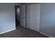 Bedroom with plush carpet, a closet, and a doorway to another room at 19025 E Bethany Pl, Aurora, CO 80013