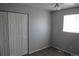 Bedroom with neutral walls, carpet, a ceiling fan, closet with bi-fold doors, and a window at 19025 E Bethany Pl, Aurora, CO 80013