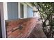 A close-up view showing the brick foundation and the blue siding of the house at 19025 E Bethany Pl, Aurora, CO 80013