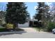 Charming single-story home with mature trees, a driveway, and an attached two-car garage at 19025 E Bethany Pl, Aurora, CO 80013