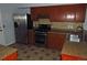Kitchen with stainless steel appliances, wood cabinets, and a tile backsplash at 19025 E Bethany Pl, Aurora, CO 80013
