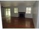 Bright living room features a brick fireplace, hardwood floors, and slider door to yard at 19025 E Bethany Pl, Aurora, CO 80013