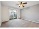 Spacious bedroom with a ceiling fan and sliding glass door to the outside at 3141 S Tamarac Dr # 206E, Denver, CO 80231