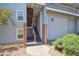 Apartment building entrance with private stairwell and mature landscaping at 3141 S Tamarac Dr # 206E, Denver, CO 80231