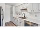 Bright kitchen features white cabinetry, stainless steel appliances, and updated countertops at 3141 S Tamarac Dr # 206E, Denver, CO 80231