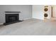 Spacious living area features plush carpet, a modern fireplace, and laundry access at 3141 S Tamarac Dr # 206E, Denver, CO 80231