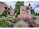 Community entrance with stone sign and lush landscaping at 3141 S Tamarac Dr # 206E, Denver, CO 80231
