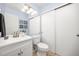 Freshly updated bathroom featuring blue accent wall, mirrored vanity, and white commode with linen storage at 6513 Pinewood Dr, Parker, CO 80134