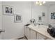 Traditional bathroom featuring decorative artwork, linen closet, and spacious vanity at 6513 Pinewood Dr, Parker, CO 80134