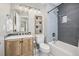 Updated bathroom with wood vanity, gray subway tile and neutral décor at 6513 Pinewood Dr, Parker, CO 80134