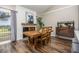 Dining room features a rustic wood table and a decorative fireplace with a large cow print at 6513 Pinewood Dr, Parker, CO 80134