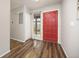 Inviting entryway with a bright red front door and wood-look flooring at 6513 Pinewood Dr, Parker, CO 80134