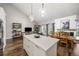 Open-concept kitchen with an island, stainless appliances, pendant lighting, adjacent to the dining and living room at 6513 Pinewood Dr, Parker, CO 80134