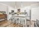 Bright kitchen with quartz countertops, stainless steel appliances, kitchen island and pendant lighting at 6513 Pinewood Dr, Parker, CO 80134