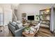 Cozy living room with a large sofa, industrial shelving and a staircase at 6513 Pinewood Dr, Parker, CO 80134