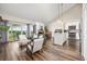 Sun-filled living room with an open floor plan to the kitchen, dining area and outdoor balcony at 6513 Pinewood Dr, Parker, CO 80134