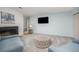 Cozy living room with fireplace, large TV, comfortable seating and neutral tones at 6513 Pinewood Dr, Parker, CO 80134