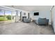 Bright living room with neutral carpet, sliding glass doors, fireplace, and comfortable seating at 6513 Pinewood Dr, Parker, CO 80134