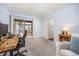 Bright office space featuring a wooden desk, slider access to an outdoor patio and neutral tones at 6513 Pinewood Dr, Parker, CO 80134