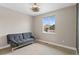 Bedroom with a sofa, ceiling fan, and large window with views of neighborhood at 7925 S Grand Baker St, Aurora, CO 80016