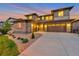 Beautiful two-story home featuring stone accents, a three-car garage, and a well-manicured lawn at 7925 S Grand Baker St, Aurora, CO 80016