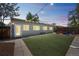 The charming backyard features artificial turf and stylish string lights that make this home the perfect place to relax at 3241 Sheridan Blvd, Wheat Ridge, CO 80212